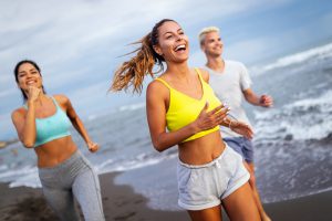 group of sport people jogging on the beach 2021 08 26 17 35 09 utc scaled